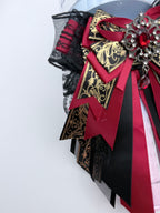 K-Pop lightstick bow decoration in burgundy and black gold brocade with gothic ruby crystal brooch