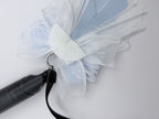 Back view of K-Pop dusty blue and white bow charm showing silver ring clip attachment