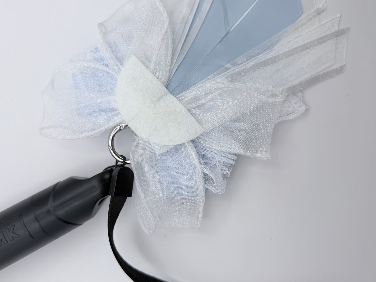 Back view of K-Pop dusty blue and white bow charm showing silver ring clip attachment