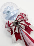 Seventeen Carat Bong lightstick bow decoration in red and white with antique silver crown brooch and ruby crystal